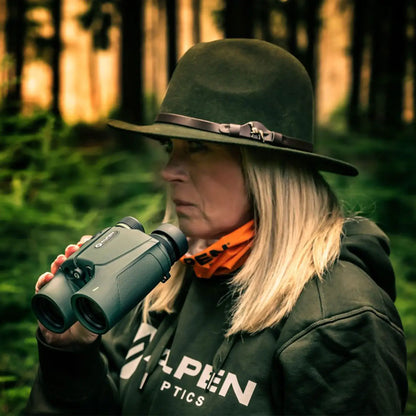 woman using the rangefinder in a wooded area.