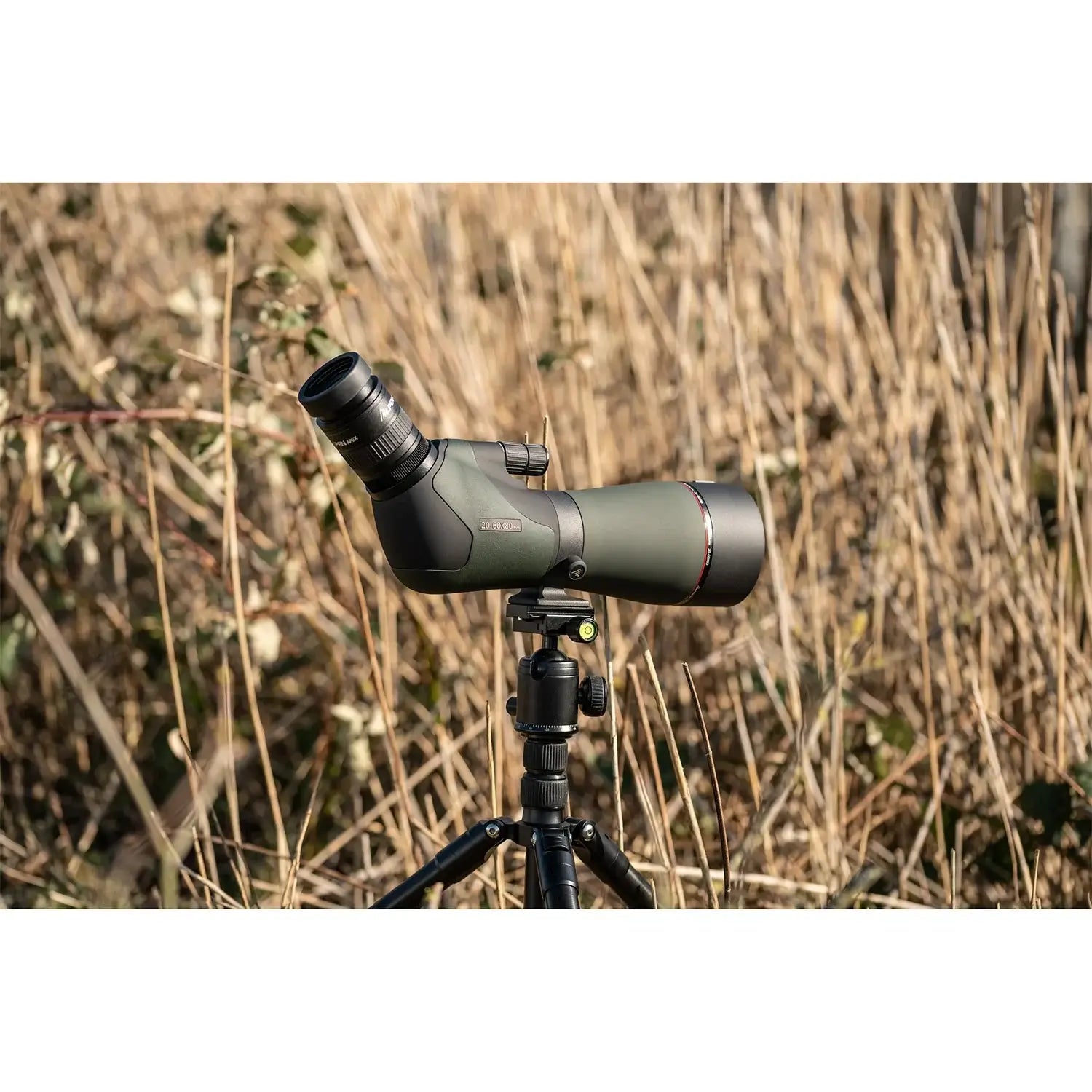 In a tall, grassy field and tripod mounted Alpen Apex XP ED Waterproof Spotting Scope.