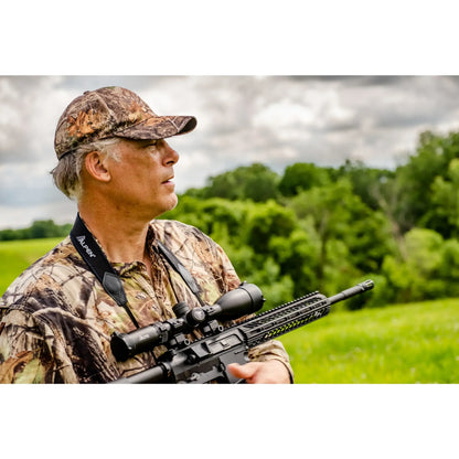 man in camo holding a rifle with an Alpen Riflescope mounted. 