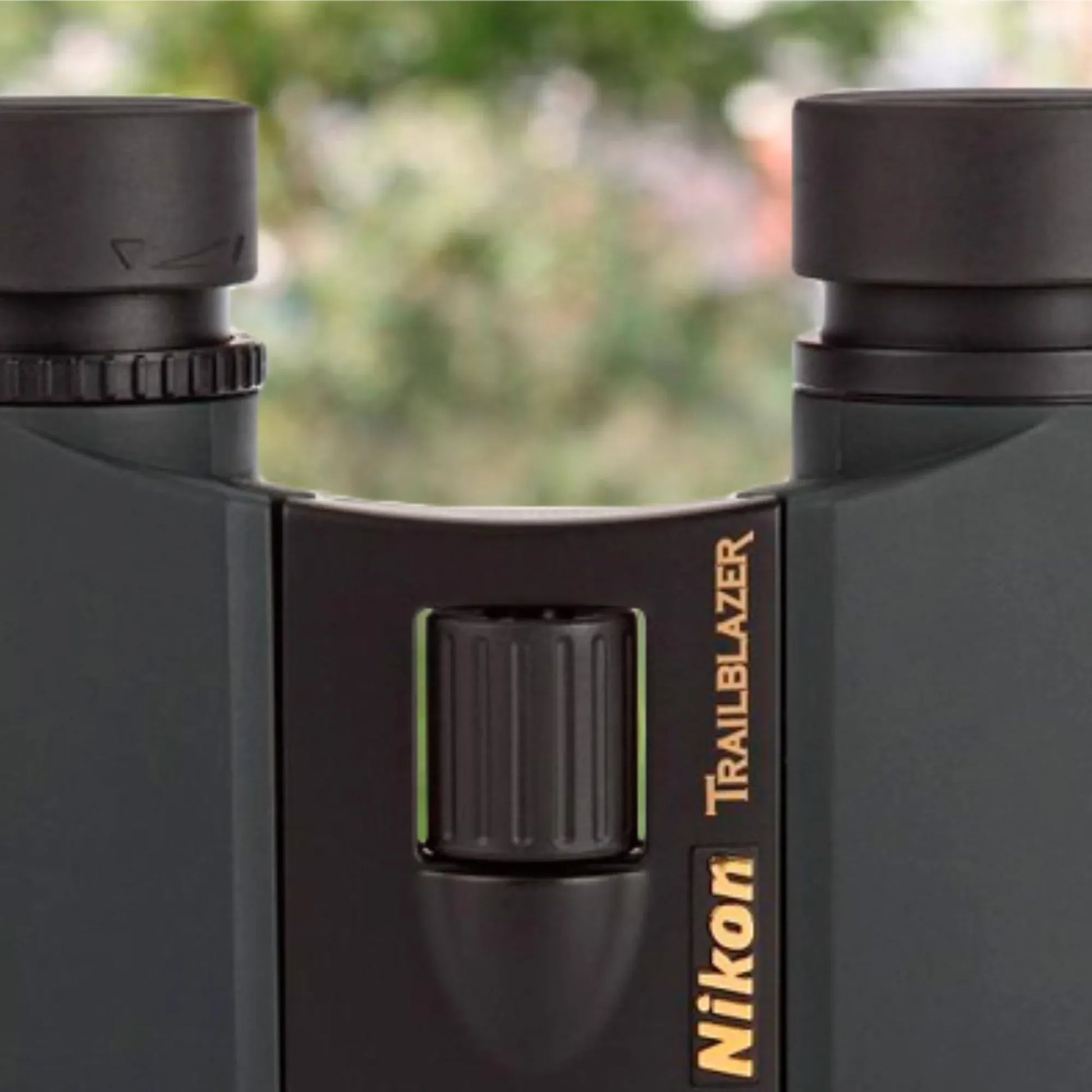 Nikon Trailblazer binoculars with a blurred natural background