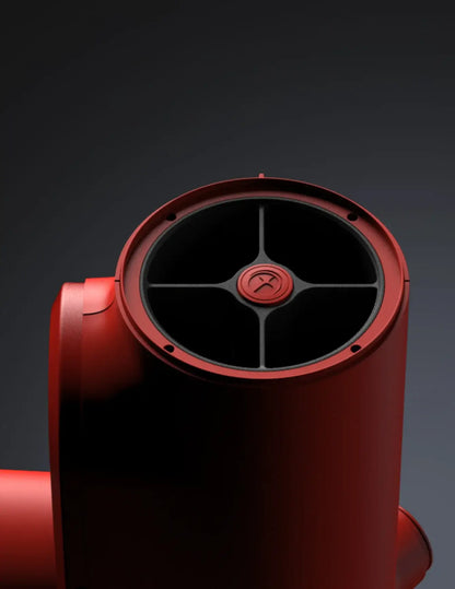 Red telescope with black central component on a dark background