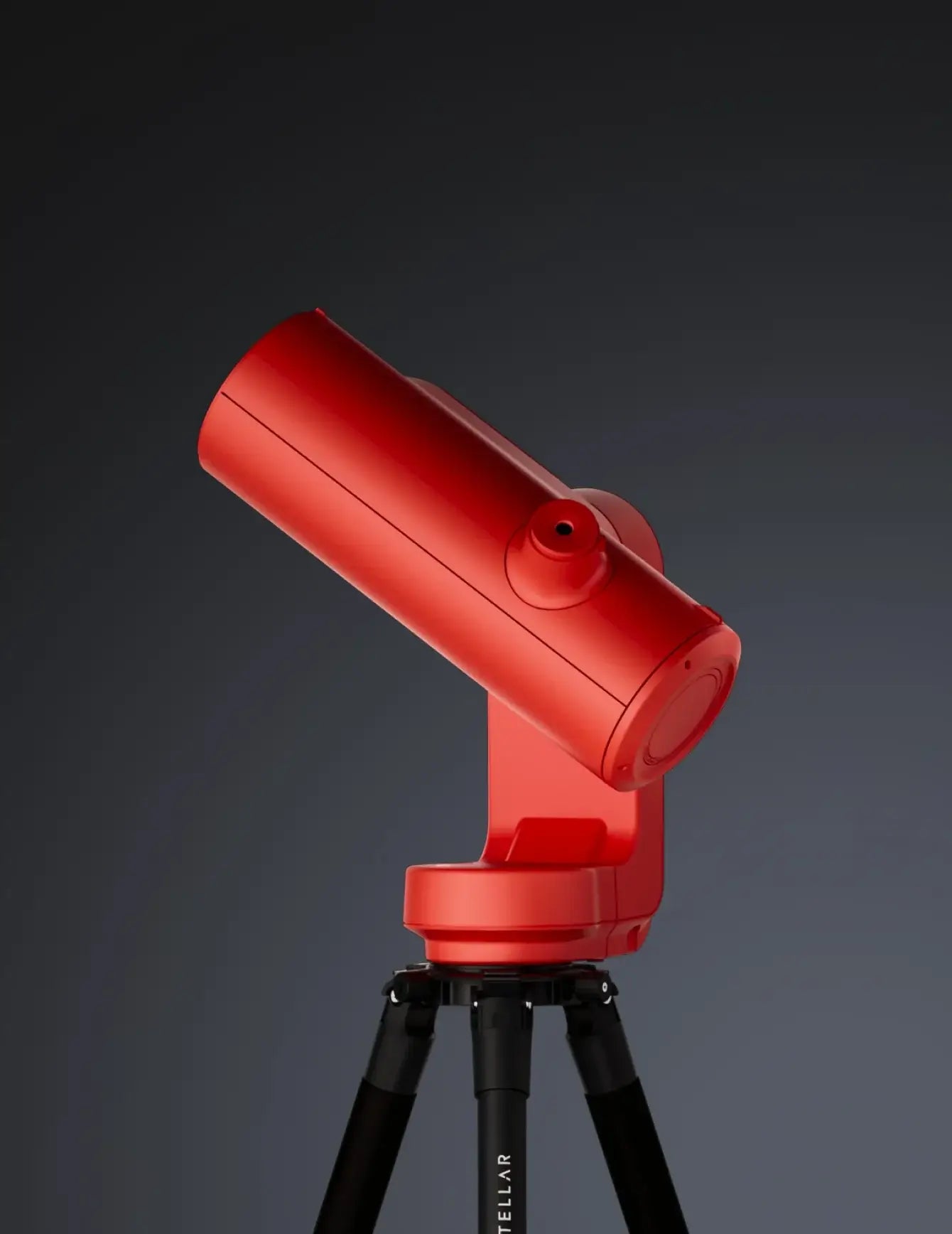 Red telescope on a black tripod against a dark background