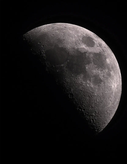 Partial view of the moon with visible craters against a black background