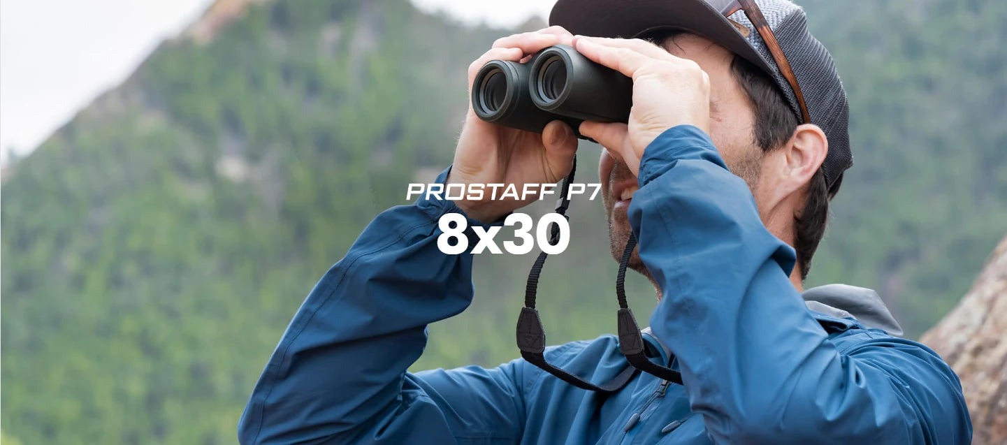 Nikon ProStaff P7 8x30 binoculars being used by a person in a mountainous region. 