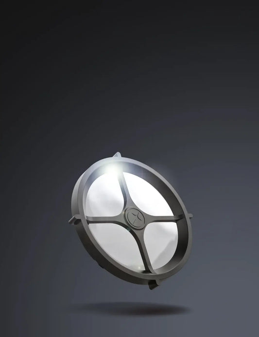 Round metallic light fixture on a dark background