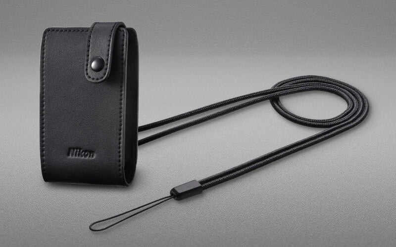 Black Nikon camera case with strap on a gray background